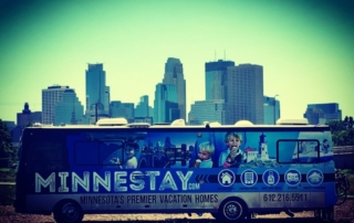 Minnestay RV in front of Minneapolis skyline.