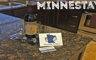 Wine bottle and Minnestay card on kitchen counter.