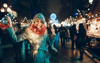 Woman with Christmas lights around her scarf.