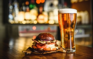 Hamburger and glass of beer.