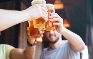 People toasting with beer glasses.