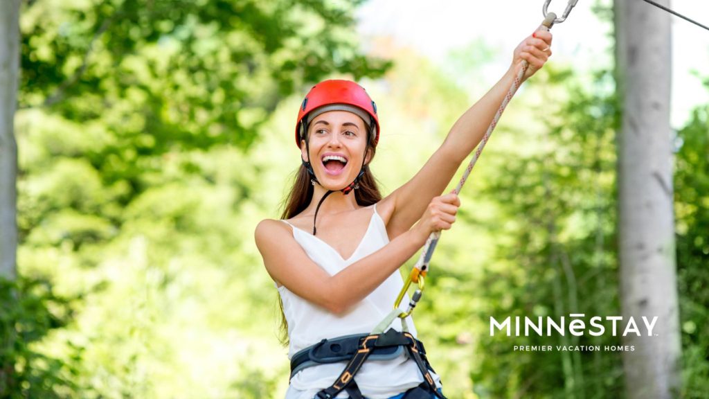 Person ziplining in one of the courses in Minnesota from in the trees 