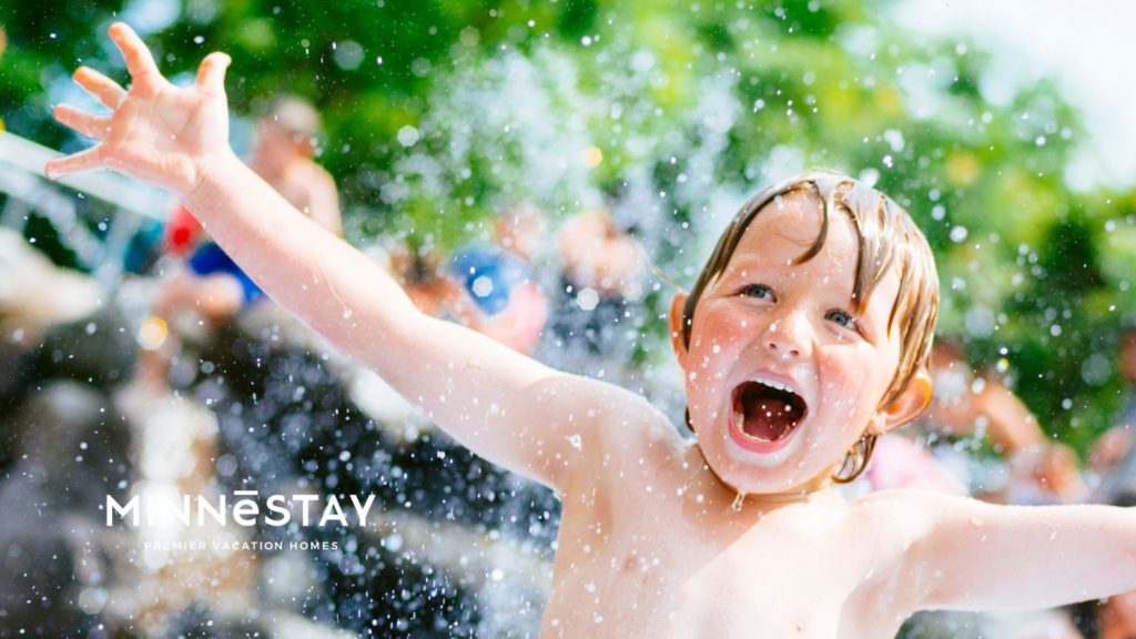 Kid playing in the splash pad at a Minnesota water park