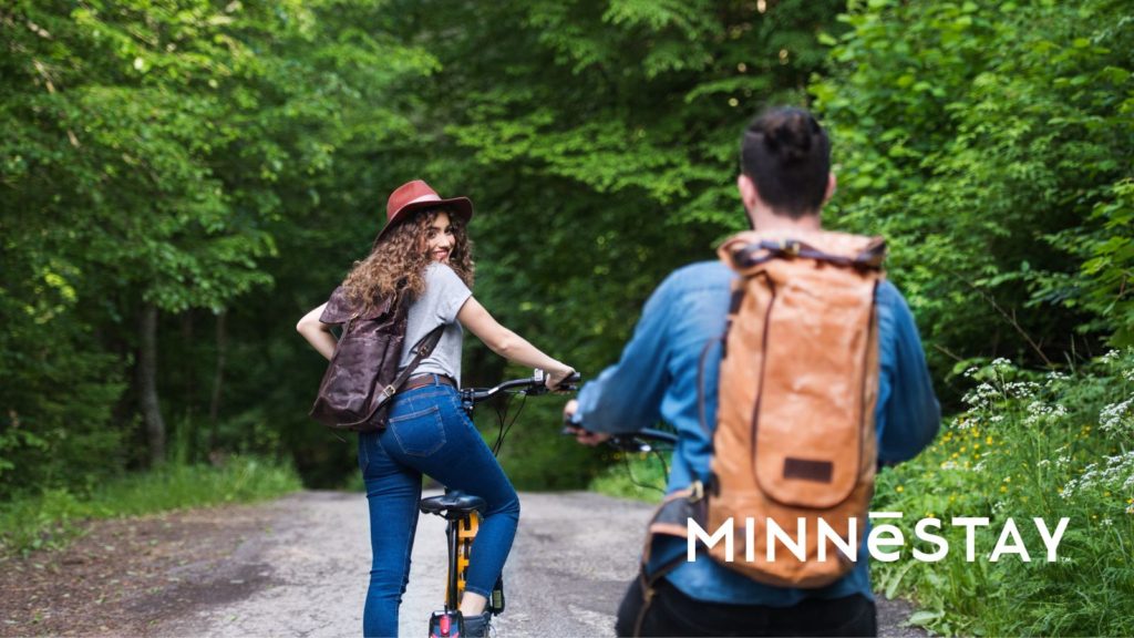 Two people on bikes in Minnesota bike trails on corporate retreat