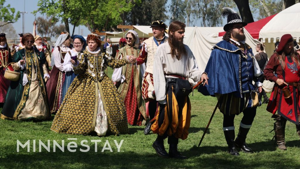 People walking at the Minneapolis Renaissance Festival in costumes.