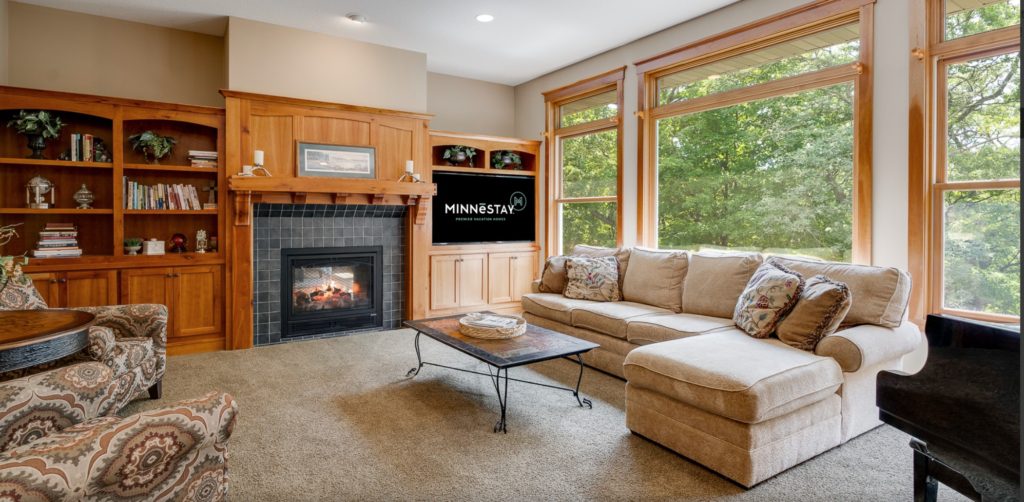 Romantic Escape at Woodhaven Retreat, shown is the living room with fireplace and views for days