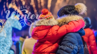 Visitors enjoying the Winter Festivals in Minnesota shown in jackets and warm hats